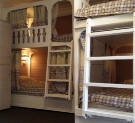 Single bed in a dormitory room for men and women